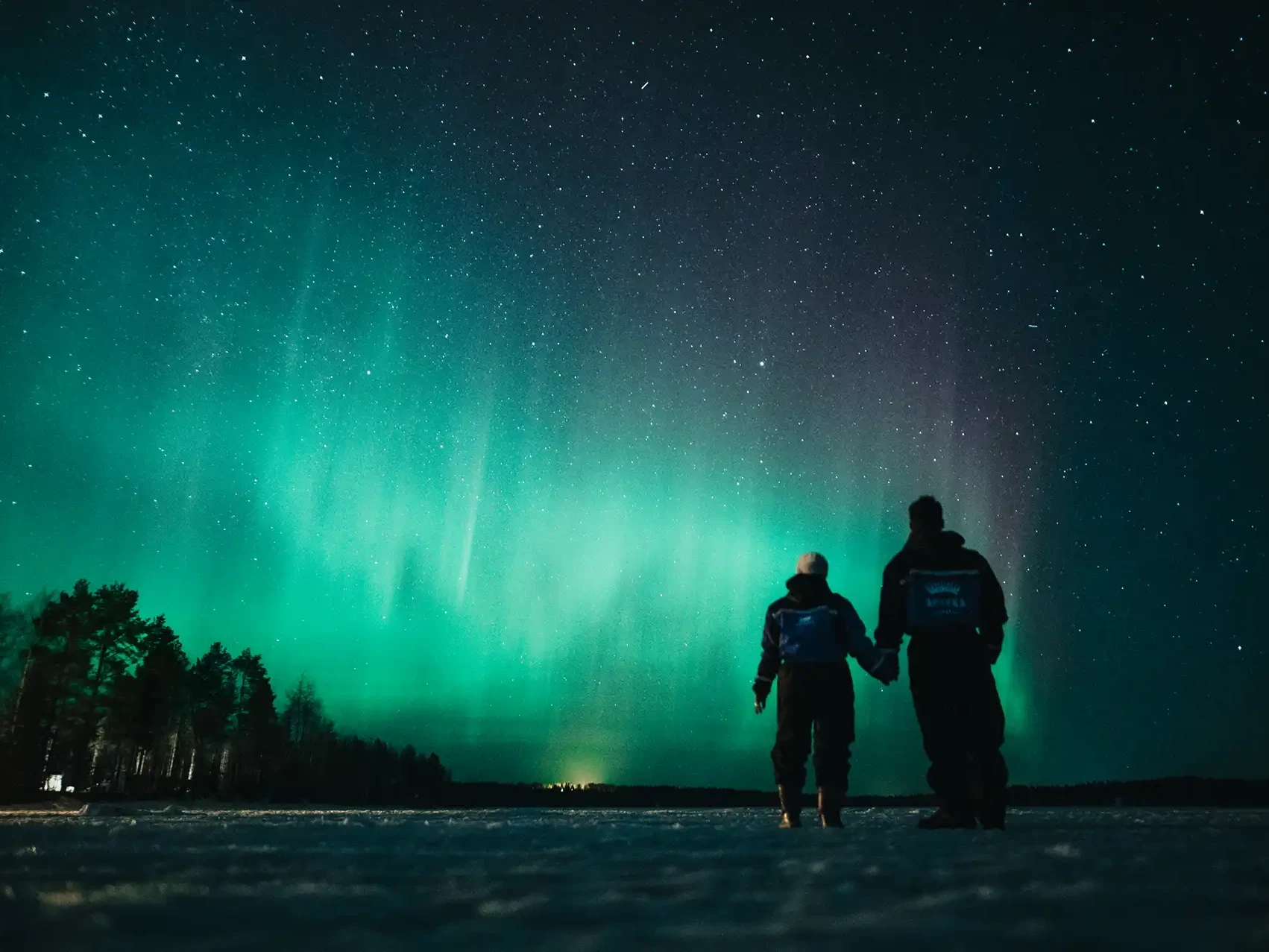 A couple looking at the Auroras in Lapland