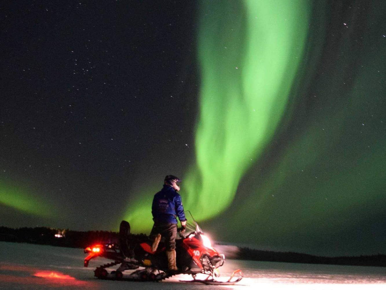 Aurora hunting tour by snowmobiles in Apukka Resort Rovaniemi Lapland Finland