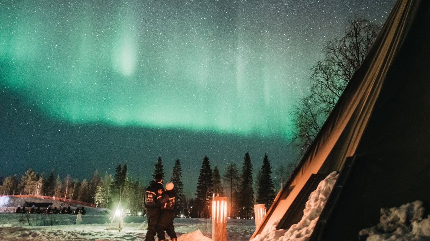 A couple watching the aurora in Lapland